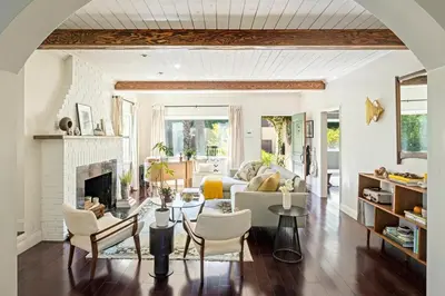 a living room with a couch and a fireplace at The Whitley Heights Sweet Escape With Jacuzzi and parking in Los Angeles