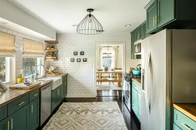 a kitchen with green cabinets and a refrigerator at The Whitley Heights Sweet Escape With Jacuzzi and parking in Los Angeles