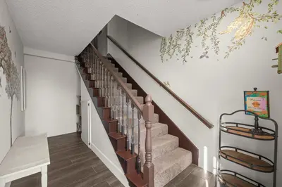 a staircase in a home with a wall mural at The Quirky Bloom-Whimsical Guest house in Upland