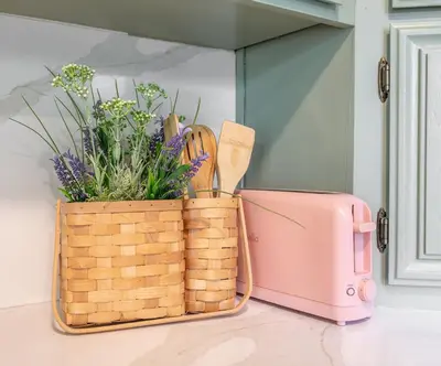 a basket with a plant and a pink suitcase at The Quirky Bloom-Whimsical Guest house in Upland