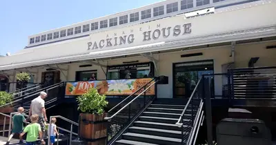 a building with people walking outside of a rocking house at Resort-Style APT with Pool, Gym & Parking 10min to Disneyland in Santa Ana