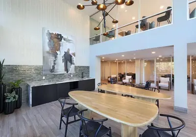 a lobby with two tables and chairs in a building at Resort-Style APT with Pool, Gym & Parking 10min to Disneyland in Santa Ana