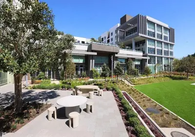 a building with a table and benches in front of it at Luxe Deco Haven with Pool, Gym & Parking Close to Disneyland in Santa Ana