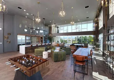 a large room with a table and chairs and a lobby at Luxe Deco Haven with Pool, Gym & Parking Close to Disneyland in Santa Ana