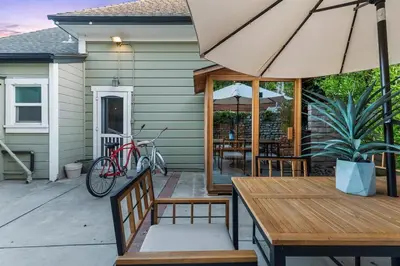 a patio with a table and an umbrella at Sea View, Sauna, Hot Tub, Beach Bikes, Stream in Ventura