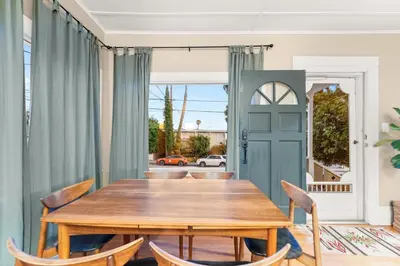 a dining room with a wooden table and chairs at Sea View, Sauna, Hot Tub, Beach Bikes, Stream in Ventura