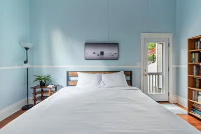 a bedroom with a large bed with a blue wall at Ocean View, Hot Tub, Sauna, Beach Bikes in Ventura