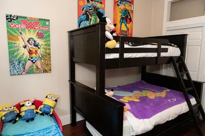 a bedroom with two bunk beds and a movie poster at Historic craftsman sleeps 9 3br2.5ba Disney 1mi in Anaheim