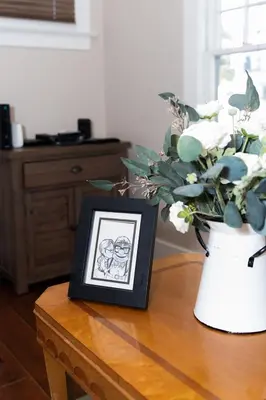 a picture and a vase with a plant on a table at Historic craftsman sleeps 9 3br2.5ba Disney 1mi in Anaheim