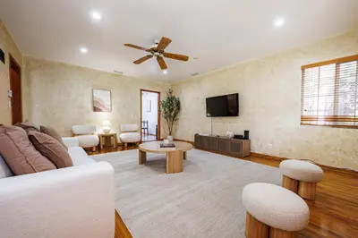 a living room with a white couch and a tv at Santa Monica 2BD Home - 20 mins to LAX Airport! in Los Angeles