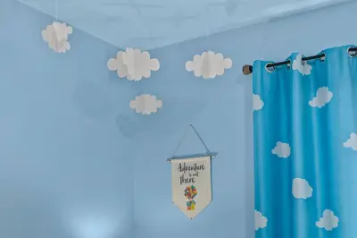 a room with a blue wall with clouds at Imagination Kingdom by OC Adventure Homes in Garden Grove