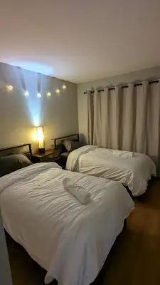 two beds in a hotel room with white sheets at Serene home in Simi valley, CA in Simi Valley