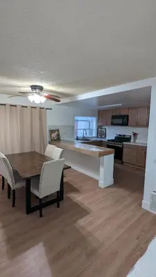 a living room with a table and a kitchen at Serene home in Simi valley, CA in Simi Valley