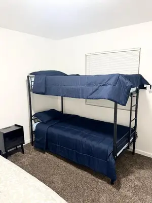 a bedroom with two bunk beds with blue sheets at LRG 1600sqft 4room 2 bath in a quiet neighborhood in Bakersfield