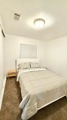 a white bedroom with a large bed in a room at LRG 1600sqft 4room 2 bath in a quiet neighborhood in Bakersfield