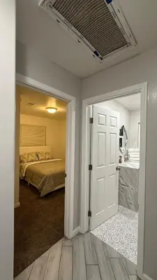 a bedroom with a bed and an open door at LRG 1600sqft 4room 2 bath in a quiet neighborhood in Bakersfield