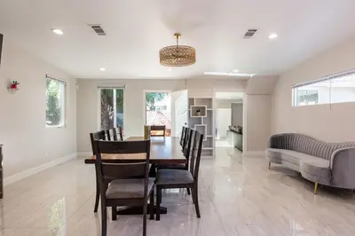 a dining room with a table and chairs at Spacious 5 BR Brand New House LAX in Inglewood