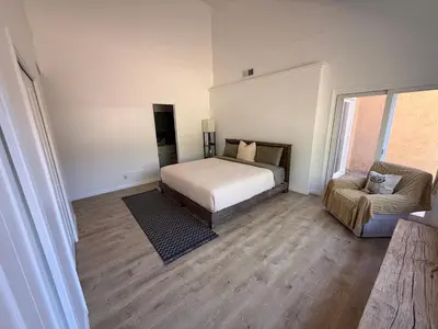 a bedroom with a bed and a chair in it at Paradise at Tree Ranch Grove in Ojai