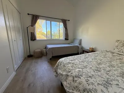a bedroom with two beds and a window at Paradise at Tree Ranch Grove in Ojai