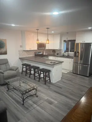 a kitchen with a table and chairs and a couch at Cozy Home Away From Home in Northridge Hospital Heliport