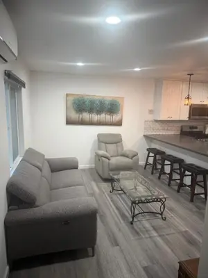 a living room with a couch and chairs and a table at Cozy Home Away From Home in Northridge Hospital Heliport