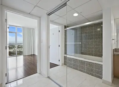 a bathroom with a shower and a glass door at Platinum Suites - Gym & Pool & Hot Tub & BBQ in Los Angeles