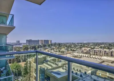 a view of the city from the balcony of a building at Platinum Suites - Gym & Pool & Hot Tub & BBQ in Los Angeles