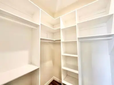 a white walk in closet with white shelves at Lovely 3-bedroom house with AC in vibrant Los Angeles Near USC in Los Angeles