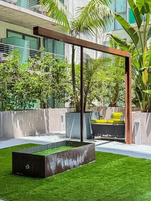 a garden with a fountain in the grass at Stylish 2BR Loft with Top-Tier Amenities - 104 - GL in Glendale