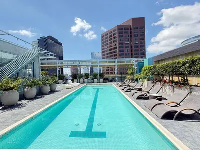 a swimming pool with chaise lounges and chairs at Cozy 2BR Loft in a Vibrant Complex - 107 - GL in Glendale