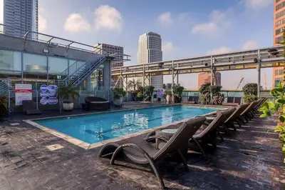 a swimming pool with lounge chairs and a building at Cozy 2BR Loft in a Vibrant Complex - 107 - GL in Glendale