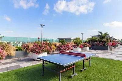 a ping pong table on a roof with potted plants at Cozy 2BR Loft in a Vibrant Complex - 107 - GL in Glendale