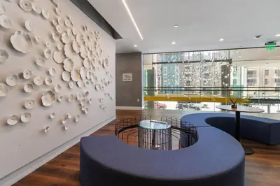a lobby with two tables and a wall with plates at Cozy 2BR Loft in a Vibrant Complex - 107 - GL in Glendale