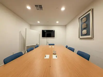 a conference room with a large wooden table and blue chairs at Cozy 2BR Loft in a Vibrant Complex - 107 - GL in Glendale