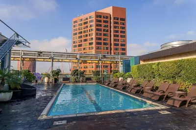 a swimming pool with chairs and a tall building at Cozy 2BR Loft in a Vibrant Complex - 107 - GL in Glendale