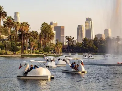 a group of people riding onlatable swans in the water at 3-Bedroom Luxury Villa Near Dodger Stadium, Downtown LA Free Parking in Los Angeles
