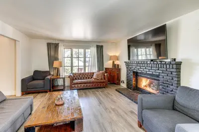 a living room with a fireplace and a couch at Beautiful Lake-View House Walk to Lake and Village! in Big Bear Lake