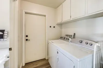 a white laundry room with a washer and dryer at Beautiful Lake-View House Walk to Lake and Village! in Big Bear Lake