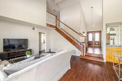 a living room with a large couch and a tv at Spacious 4-bedroom family house-20 mins to Disney Land in Rowland Heights
