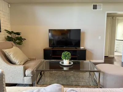 a living room with a couch and a tv at Spacious 4-bedroom family house-20 mins to Disney Land in Rowland Heights