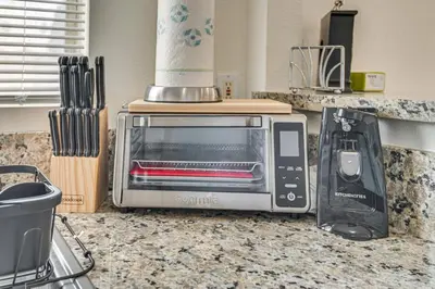 a toaster oven sitting on top of a kitchen counter at Near Hospitals and Metrolink Access LA Getaway in Los Angeles