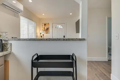 a kitchen with a black chair at a counter at Near Hospitals and Metrolink Access LA Getaway in Los Angeles