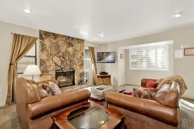 a living room with a couch and a fireplace at Summit Ski Resort Mountain View Condo - Walk to Snow Summit in Big Bear Lake