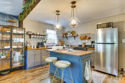 a kitchen with blue cabinets and a refrigerator at Hike, Ski, Relax Mtn Getaway in Lake Arrowhead in Lake Arrowhead