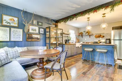 a kitchen with blue walls and a table and chairs at Hike, Ski, Relax Mtn Getaway in Lake Arrowhead in Lake Arrowhead
