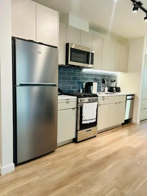 a kitchen with a stainless steel refrigerator and appliances at Heart of Hollywood Walk of Fame - Free Parking, Pool, Gym, Rooftop Views, centrally located, WIFI in Los Angeles