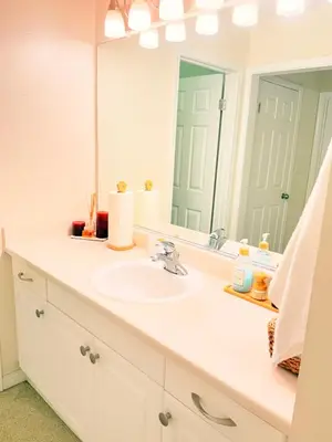 a bathroom with a sink and a large mirror at Luxury stay by Gaia Homes in Los Angeles
