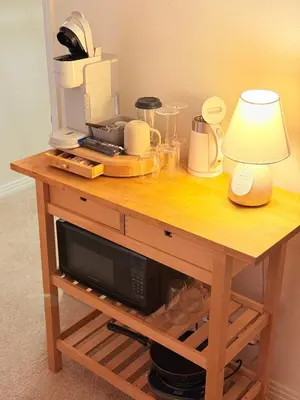a wooden table with a microwave and a lamp on it at Luxury stay by Gaia Homes in Los Angeles