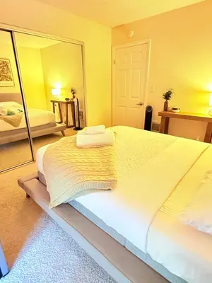 a bedroom with a large bed with a large mirror at Luxury stay by Gaia Homes in Los Angeles