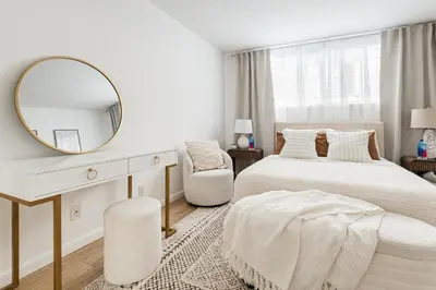 a bedroom with a bed and a mirror and a chair at Ocean Breeze Retreat in Los Angeles